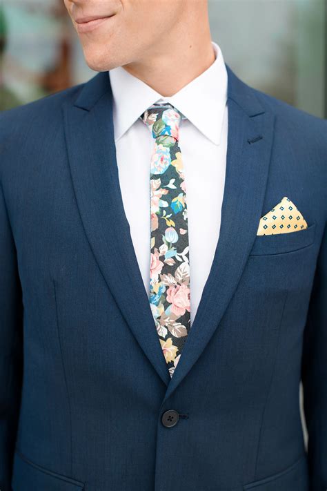 navy suit with floral tie.